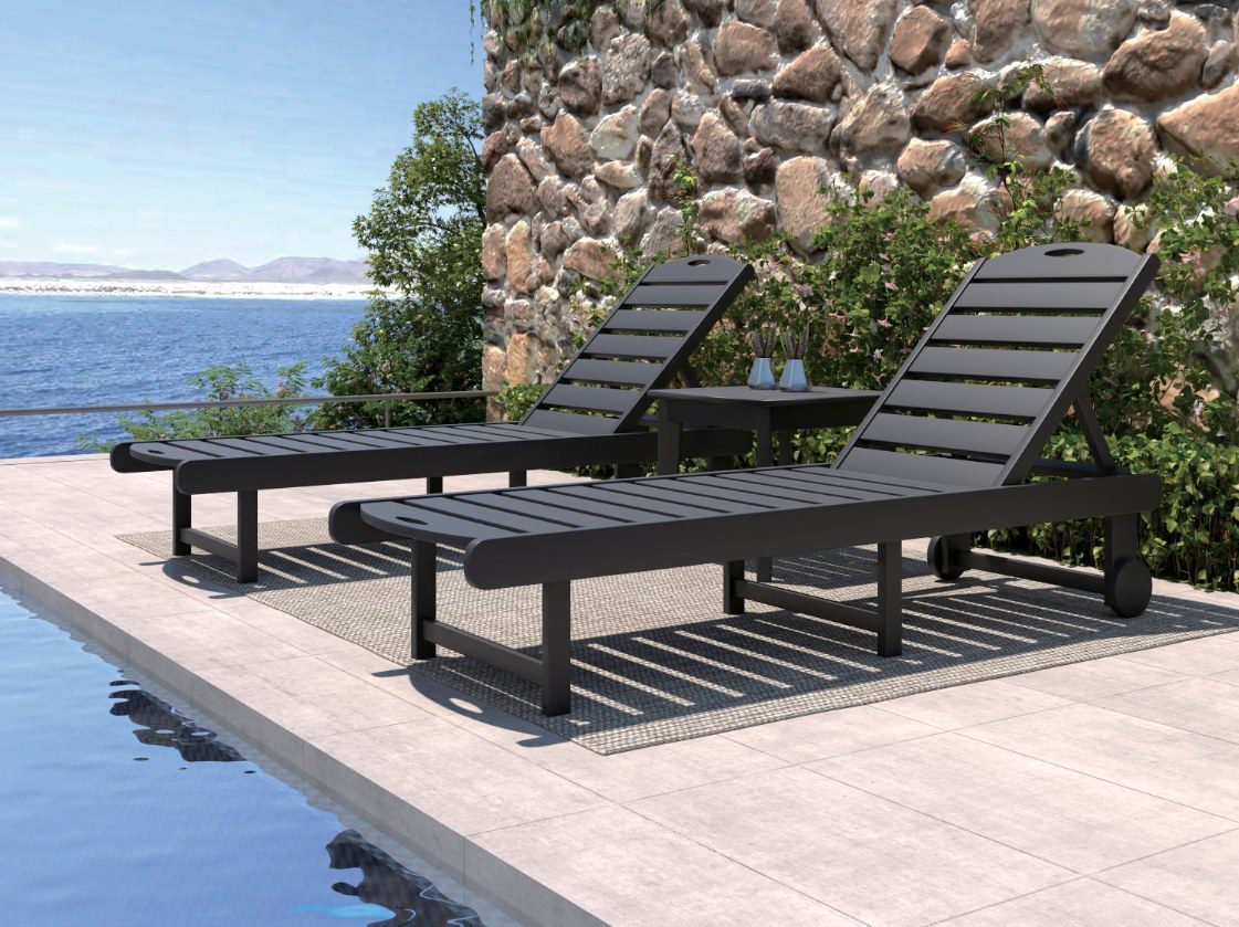 Black HDPE sun loungers beside a pool